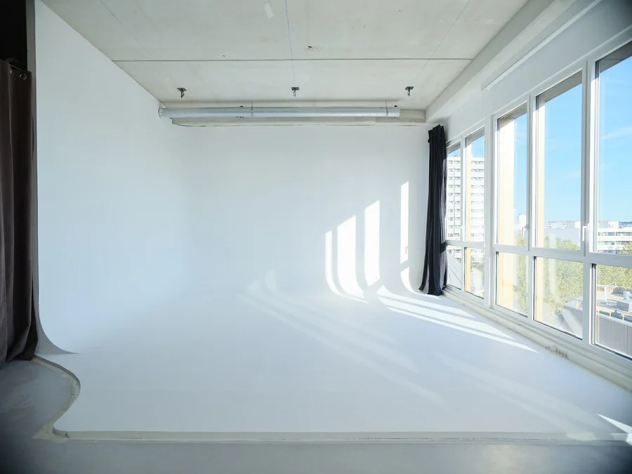 White studio cyclorama with sunlight coming through the windows